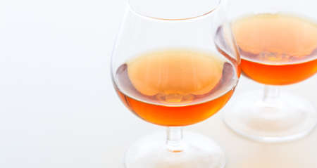 Two crystal cognac glasses on white backgroundの写真素材