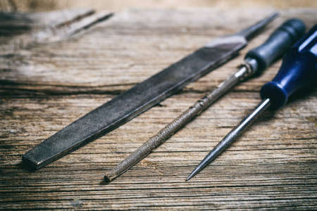 Old hand tools on a wooden background