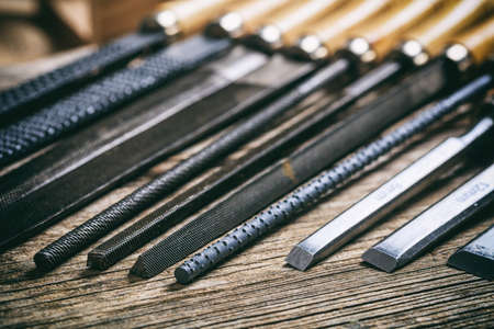 Old hand tools on a wooden background