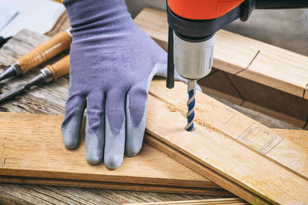 Man with gloves working with a drillの写真素材