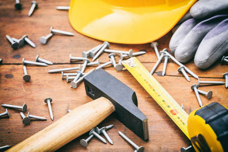 Hammer and nails on a wooden tableの写真素材