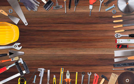 Set of hand tools with copy space on wooden background