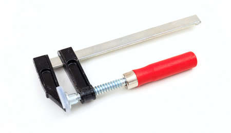 Metal clamp with red handle isolated on white background