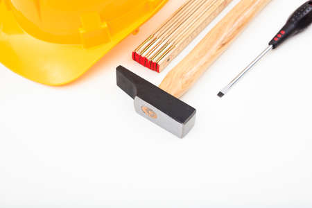 Hard hat and hand tools on white backgroundの写真素材