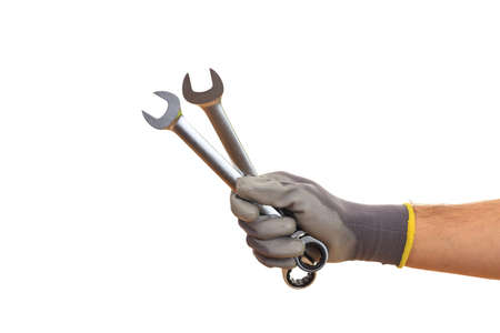 Hand holding two spanners on white backgroundの写真素材