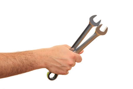 Hand holding two spanners on white backgroundの写真素材