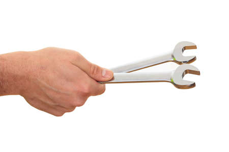 Hand holding two spanners on white backgroundの写真素材