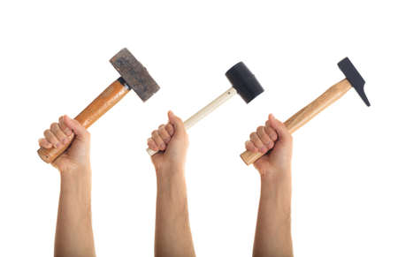 Hands holding various hammers on white backgroundの写真素材
