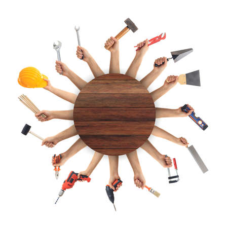 Hands holding hand tools on white backgroundの写真素材