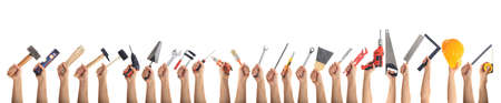 Hands holding hand tools on white backgroundの写真素材