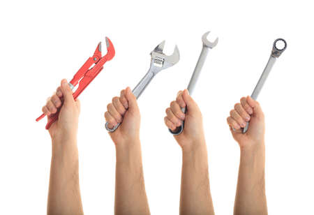 Hands holding hand tools on white backgroundの写真素材
