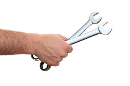 Hand holding two spanners on white backgroundの写真素材