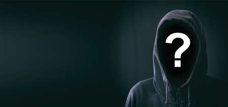 Hooded faceless man on black backgroundの写真素材