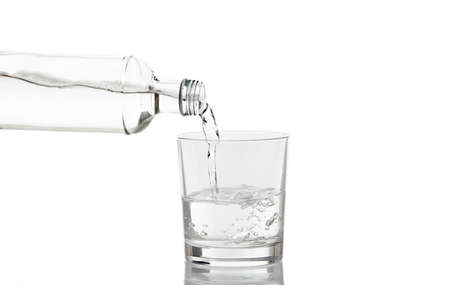 Glass and bottle of water on white backgroundの写真素材