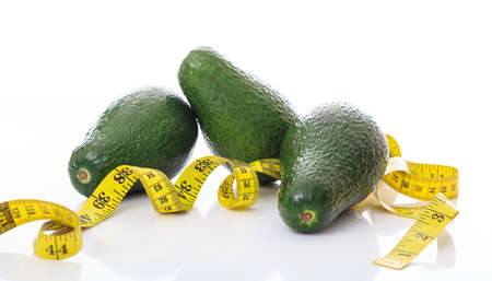 Avocados and measure tape isolated on white backgroundの写真素材