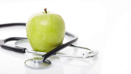 Apple and stethoscope on white backgroundの写真素材