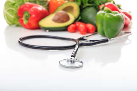 Variety of fresh vegetables and stethoscope on white backgroundの写真素材