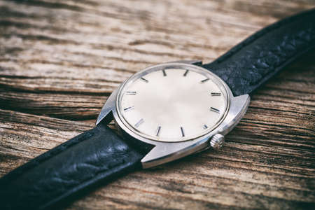 Silver vintage watch on wooden backgroundの写真素材