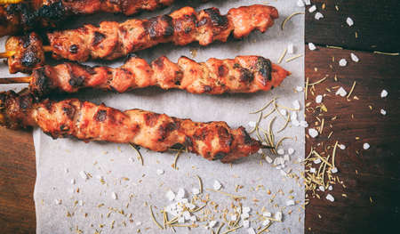 Grilled meat skewers on a wooden backgroundの写真素材
