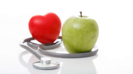 Apple and stethoscope on white backgroundの写真素材