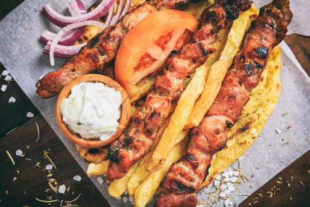 Grilled meat skewers on a wooden backgroundの写真素材