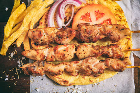 Grilled meat skewers on a wooden backgroundの写真素材
