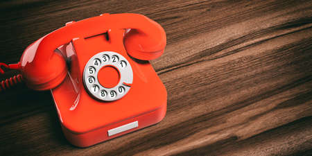Red old telephone isolated on wooden background. 3d illustrationの写真素材