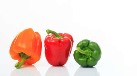 Colorful bell peppers isolated on white backgroundの写真素材