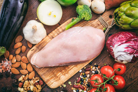 Raw chicken breast on wooden backgroundの写真素材