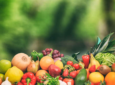 Variety of fresh fruits and vegetables on nature backgroundの写真素材
