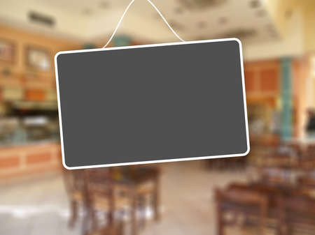 Grey sign hanging on a glass storefrontの写真素材