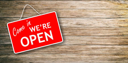 We are open sign hanging on wooden backgroundの写真素材