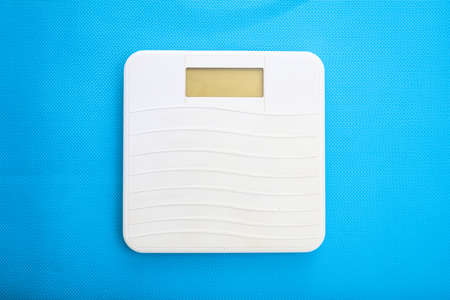 White bathroom scale on a blue backgroundの写真素材