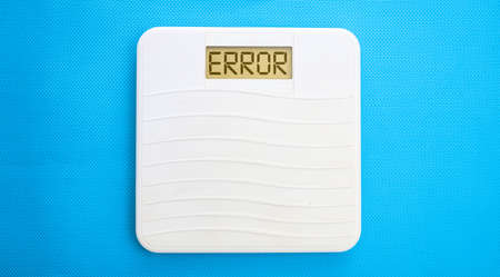 White bathroom scale on a blue backgroundの写真素材