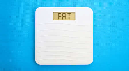 White bathroom scale on a blue backgroundの写真素材