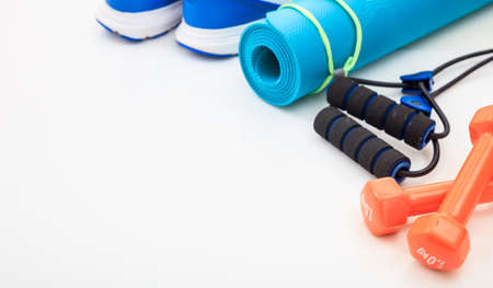 Yoga mat and dumbbells on white backgroundの写真素材