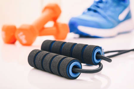 Expander and dumbbells on white backgroundの写真素材