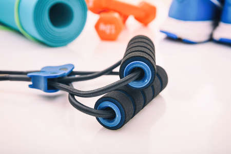 Expander and fitness equipment on white background