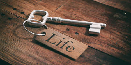Old metal key with label life on a wooden background. 3d illustrationの写真素材