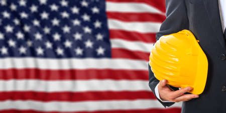 Engineer on a waiving United States of America flag background. 3d illustrationの写真素材