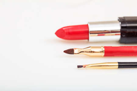 Lipstick and brushes close up on white backgroundの写真素材
