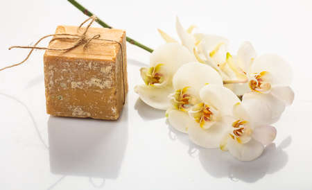 Natural handmade soap bar and orchid on white backgroundの写真素材
