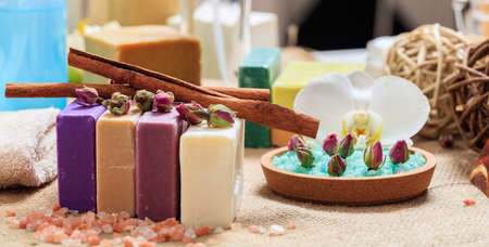 Variety of handmade soap bars on wooden background