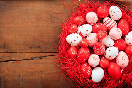 Colorful Easter eggs decoration and copy space on wooden backgroundの写真素材