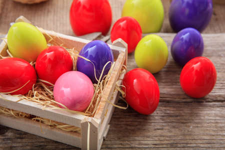 Colorful Easter eggs decoration on wooden backgroundの写真素材