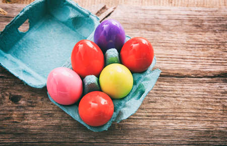 Colorful Easter eggs decoration and copy space on wooden backgroundの写真素材