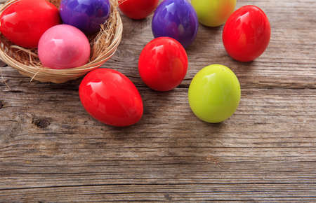 Colorful Easter eggs decoration and copy space on wooden backgroundの写真素材