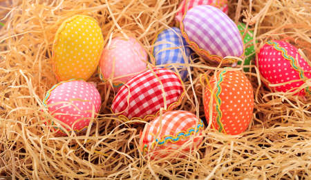 Colorful pastel Easter eggs on straw backgroundの写真素材