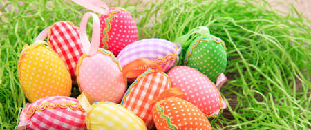 Variety of colorful Easter eggs on grassの写真素材