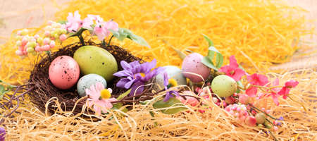 Easter eggs decoration on straw backgroundの写真素材